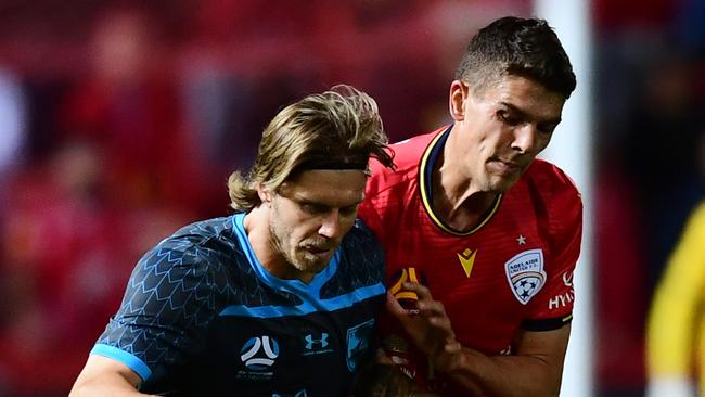 Adelaide United’s George Blackwood and Sdney FC’s Luke Brattan during the opening of the 15th A-League season at Coopers Stadium last Friday. (Photo by Mark Brake/Getty Images)