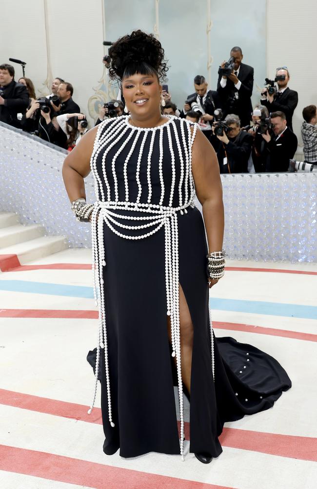 Lizzo ore a custom a black silk crêpe dress with a glass pearls harness. Picture: Getty Images