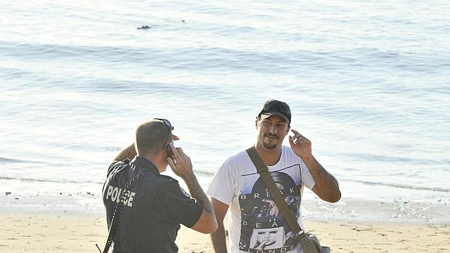 Al and a police officer have a chat about the optimum safe distance between oneself and a dangerous reptile. Photo: DANIEL HARTLEY-ALLEN