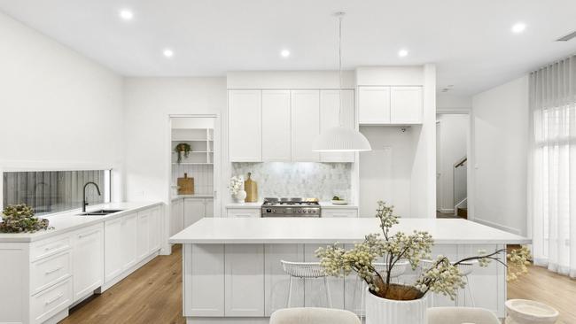 The kitchen features a butler’s pantry, integrated dishwasher and stainless steel cooker.