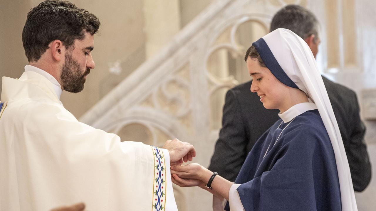 Father Nathan Webb gives Holy Communion to his sister, Sister Rose Patrick O'Connor, who travelled from New York for the ordination of her brother. Picture: Nev Madsen.