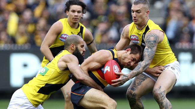 Richard Douglas gang-tackled by Bachar Houli and Dustin Martin. Picture: Sarah Reed