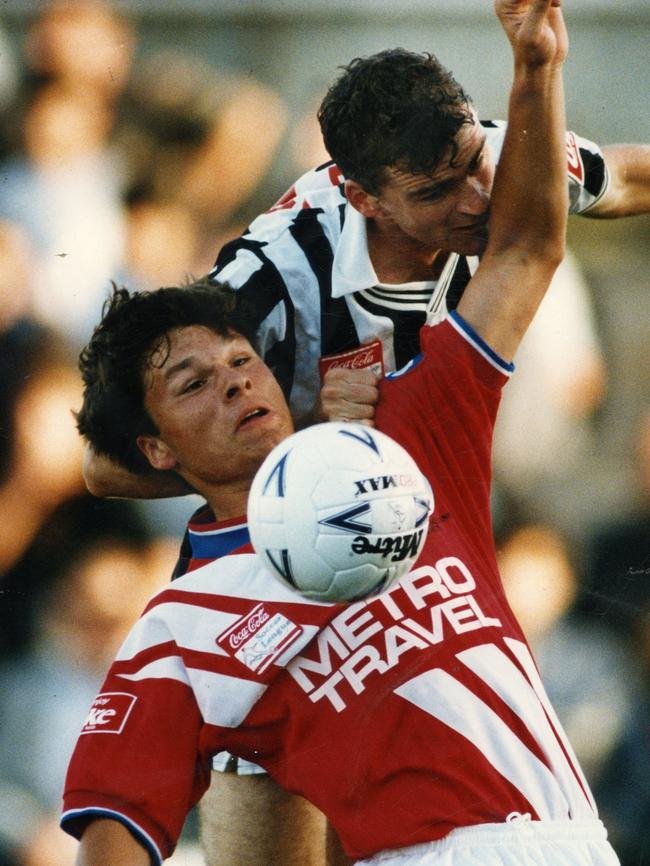 Adelaide City captain Alex Tobin (top) and Melbourne Knights’ Mark Viduka compete for possession.