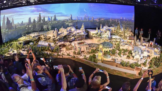 Members of the media get their first look at a detailed model of Star Wars land.