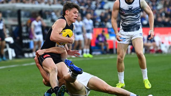 Sam Walsh is tackled by Mark O'Connor, but was prominent throughout with a big game.