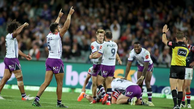 Melbourne Storm celebrate the tough victory over Sydney Roosters at Adelaide Oval on Friday night. Picture: Kelly Barnes/AAP