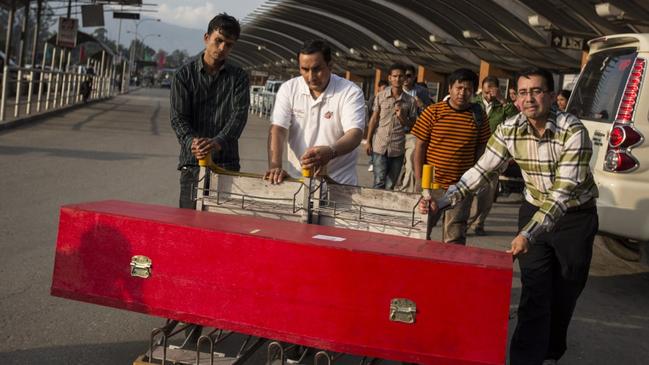 “Sometimes there are so many cases (coffins) that we have to rush back to the capital as soon as we drop off one coffin for the next delivery.”. Picture: Mathilde Gattoni