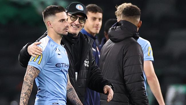 Mombaerts walks off with star striker Jamie Maclaren after the grand final defeat.