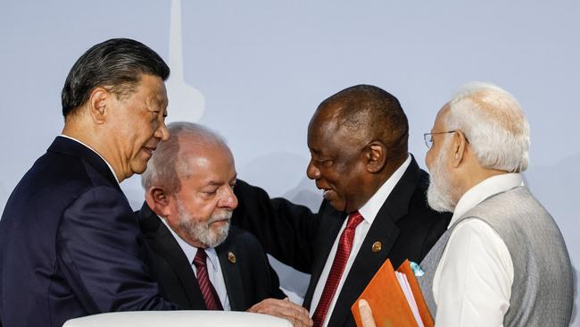 Xi Jinping gets into the bonhomie at the BRICS summit in Johannesburg last week with Brazil’s Luiz Inacio Lula da Silva, South Africa’s Cyril Ramaphosa and Narendra Modi of India. Picture: AFP