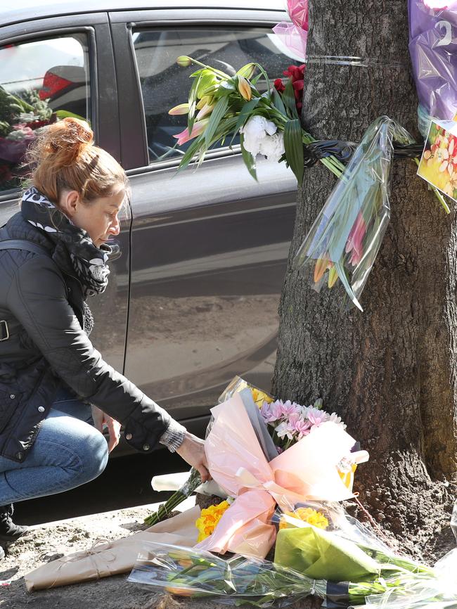 Suzanne Wright lays flowers at the site where a cyclist was killed on Chapel St. Picture: David Crosling