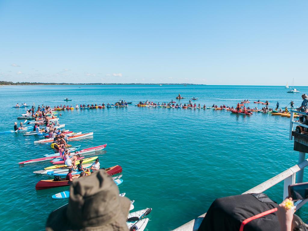 Paddle board formation in water at Paddle Out for Whales.