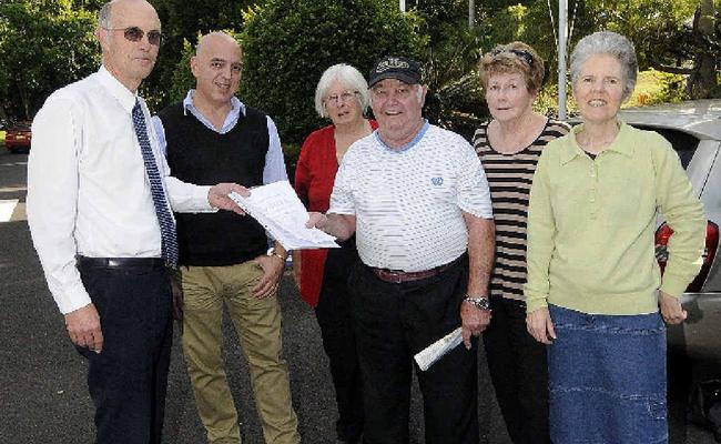 LOVERS OF LITERATURE: Graeme and Janine Wilson, Peter Harris of Lismore Community Action network, Trish Gibson of Friends of the Library and supporter Corena Wynd hand a 904-signature petition to Lismore Council corporate compliance co-ordinator Gianpiero Battista in a bid to save Goonellabah Library. Picture: Doug Eaton