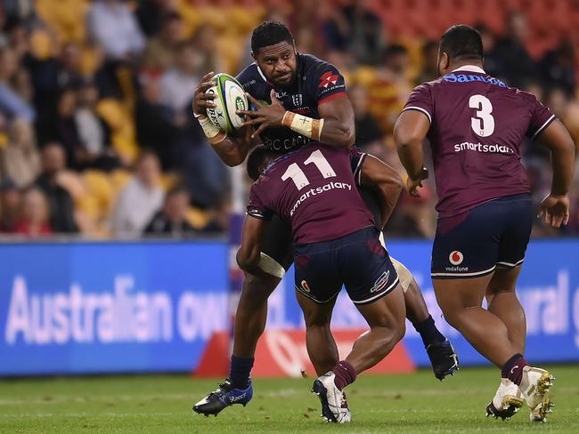 The Rebels Isi Naisarani is tackled by Reds winger Filipo Daugunu. Picture: Albert Perez/Getty Images