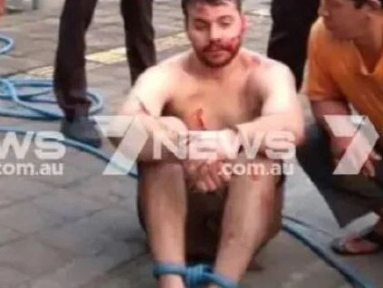 Nicholas Carr tied up with hosepipe by local people. Picture: Channel 7