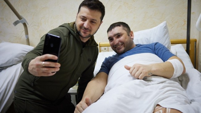 Ukrainian President Vladimir Zelenskiy takes a photo with a wounded soldier by Russian attacks on Ukraine during his hospital visit in Kyiv. Picture: Ukrainian Presidency/Anadolu Agency via Getty Images