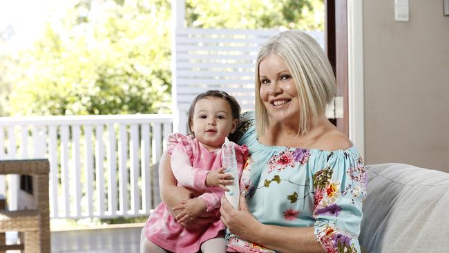 Aaliyah Hannaoui, 1, and Laura Klein at their home in Brisbane. Laura developed the Snotty Boss which removes snot through battery powered suction for young children. (Image/Josh Woning)