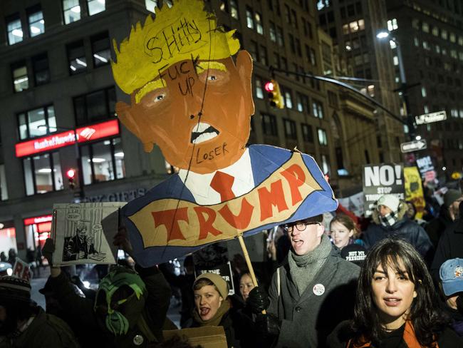 NEW YORK, NY - FEBRUARY 7: (EDITORS NOTE: Image contains profanity.) Activists rally against President Donald Trump's reported plans to loosen Wall Street Regulations and repeal the Dodd-Frank Act as they march toward Goldman Sachs headquarters in Lower Manhattan, February 7, 2017 in New York City. The Dodd-Frank Wall Street Reform and Consumer Protection Act was signed into law by President Barack Obama in July 2010 in response to the financial crisis of 2007-2008. Drew Angerer/Getty Images/AFP == FOR NEWSPAPERS, INTERNET, TELCOS & TELEVISION USE ONLY ==