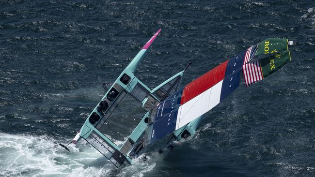 The USA SailGP Team F50 catamaran is recovered by a support crew after it capsized whilst being towed on to the race area for a practice session ahead of the KPMG Australia Sail Grand Prix in Sydney, Australia. Friday 7 February 2025. Rolex SailGP Championship Event 3 Season 2025. Photo: Jon Buckle for SailGP. Handout image supplied by SailGP