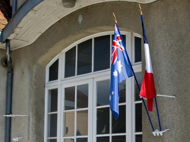 The Australian flag flies alongside the French flag at the entrance of a school in Villers-Bretonneux. Picture: David Dyson