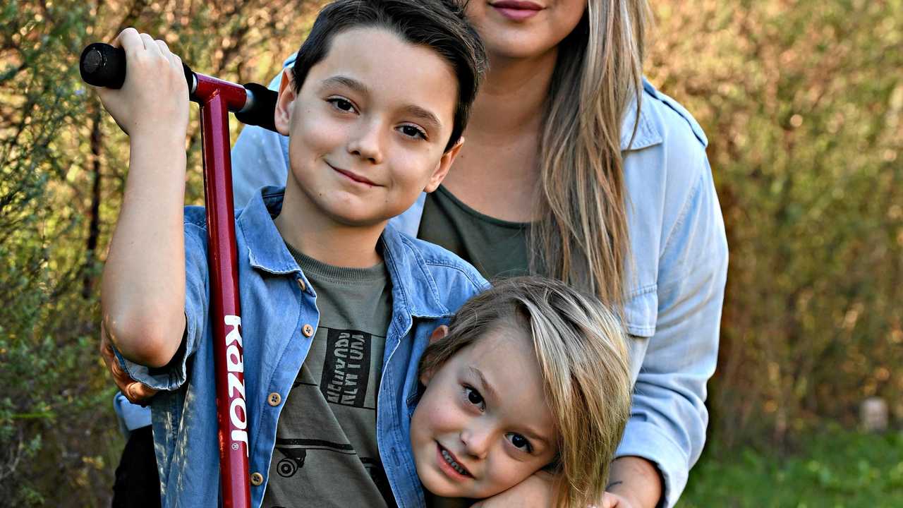 LAST HOPE : The Wooster family hopes to give Kobe (left) a 24/7 assistance dog to help him manage his autism and anxiety. Kobe, 9, is pictured with his brother Harrison, 4, and mum Kiaona. Picture: Warren Lynam