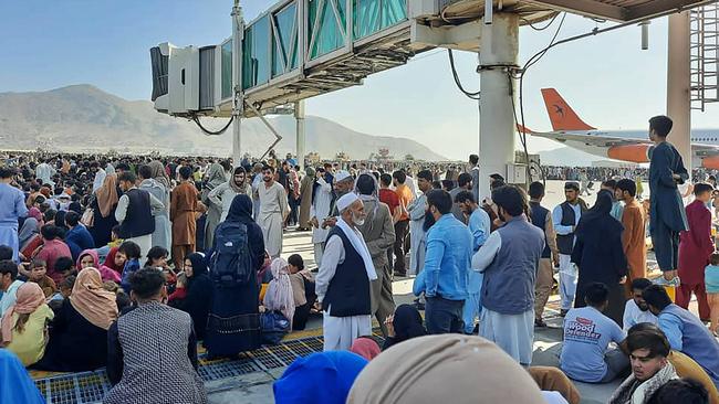 Afghans crowd the tarmac of the Kabul airport on Monday. Picture: AFP