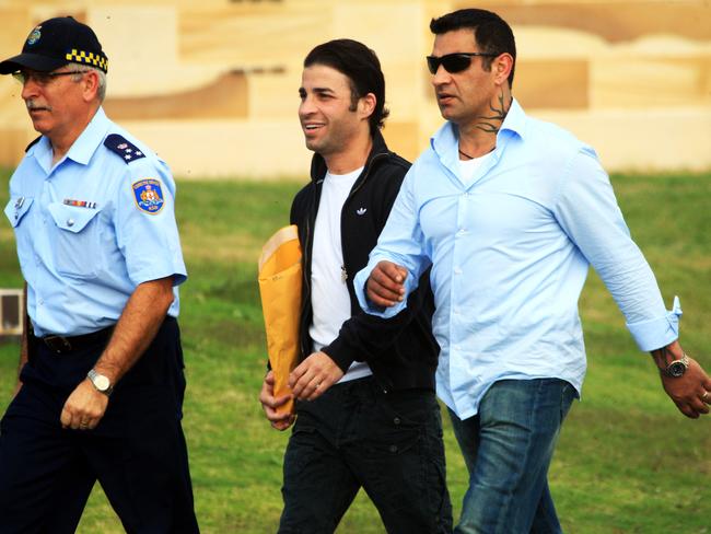 Fadi (centre) and Sam Ibrahim (right) being escorted to the gate by a guard at the Long Bay Correctional Complex in Sydney.