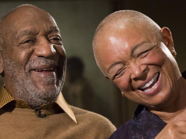 FILE - In this Nov. 6, 2014 file photo, entertainer Bill Cosby and his wife Camille laugh as they tell a story about collecting one of the pieces in the upcoming exhibit, 
