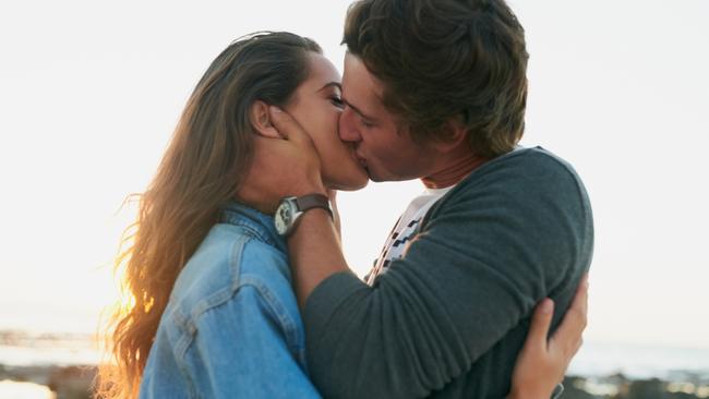 Shot of an affectionate young couple bonding at the beachCouple kissing at the beachRomance and love at the beachPicture: iStock