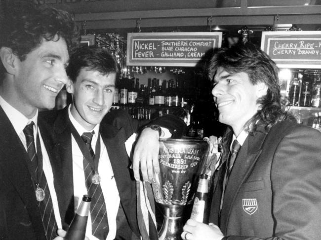 Gary Ayres (right) on the squirt with Dean Anderson and Anthony Condon after Hawthorn’s 1991 grand final victory.