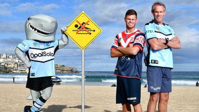 Sharks mascot at Bondi Beach with Sutherland Shire lifeguard Jon Lavers and Bondi lifeguard Harrison Reid. (NRLPhotos/Gregg Porteous)