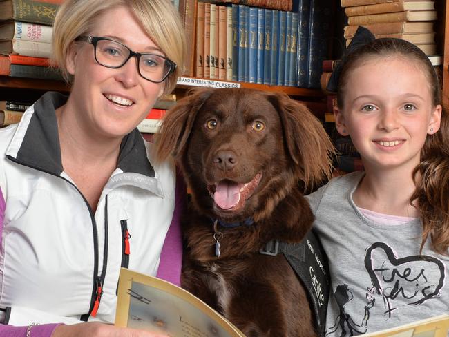 Sarah Macdonald is an English teacher who runs a children's Literacy Business called Canine Comprehension. They use Animal Assisted Therapy dogs to assist in the learning process. By using a canine friendly face, children are motivated to read aloud to the dogs without the embarrassment of making mistakes. They are running a free ANZAC Day Event in conjunction with a local Business in The Basin Rainy Day Books. In an effort to inspire kids to read, and on this day, read stories about our past servicemen, Canine Comprehension will be running reading sessions, where kids can snuggle up to the dogs and hear stories about our diggers and their special service dogs. Pictured with 'Oscar' the dog are Sarah Mcdonald and her niece Caitlin,10. Picture: Lawrence Pinder