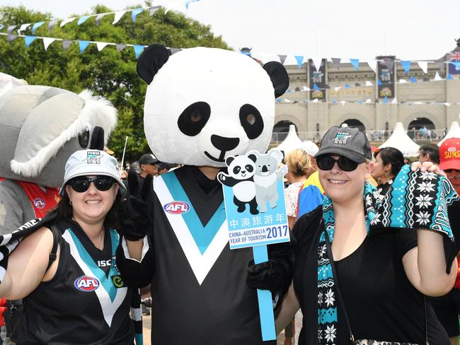 Port Adelaide fans Maddie Seymour and Kallie Gordon with a Port mascot ahead of game. Picture: AAP