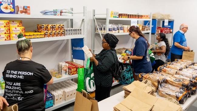 Shoppers at Logan’s free grocery store, where people can pick up 18 items including three frozen meals, for free. Pictures: Contributed