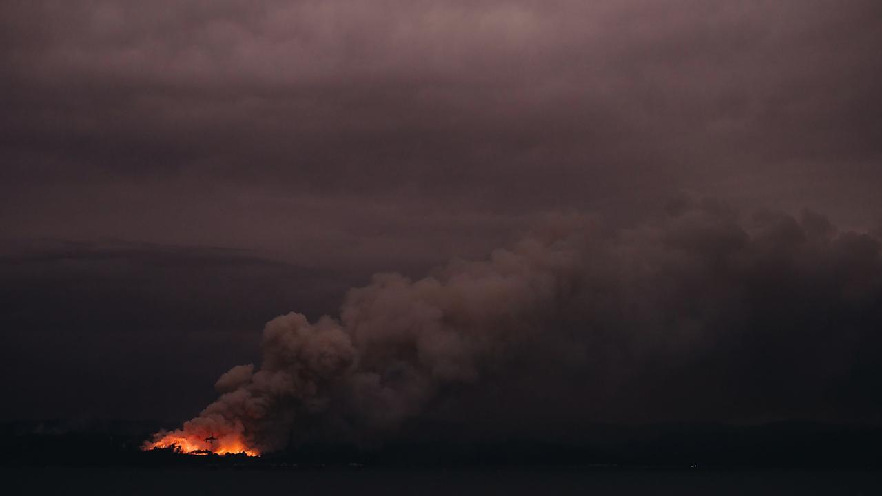 Afire seen from the Royal Australian Navy's HMAS Adelaide ship off the coast in Eden in New South Wales. Picture: Australian Department of Defence / AFP