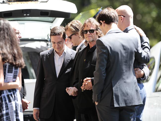 23. On the same day, just 100 metres from the Lindt cafe Tori Johnson was laid to rest at St Stephens Uniting Church. This photographs shows Tori’s partner of 14 years, Thomas Zinn, Tori’s father Ken Johnson and brother James Johnson. Picture: Adam Yip