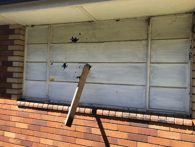 A fence paling was shoved through a boarded up window at the former North Manly Bowling Club. Picture: Jim O'Rourke