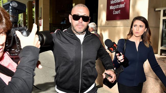 Toby Mitchell clashes with the media pack outside Melbourne Magistrates Court. Picture: Jay Town