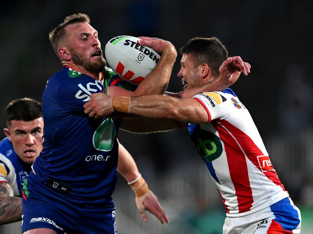 Kurt Capewell fights to break free of a Jack Cogger tackle.