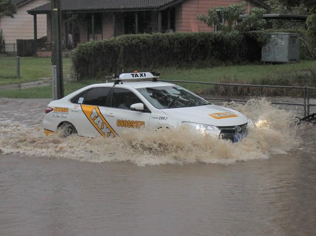 Flooding on Bray St, Coffs Harbour on Wednesday March 18. Cars unwilling to take a 1 minute and 47 second detour drive through floodwaters on Bray St after Council closed the road. Coffs Harbour floods.