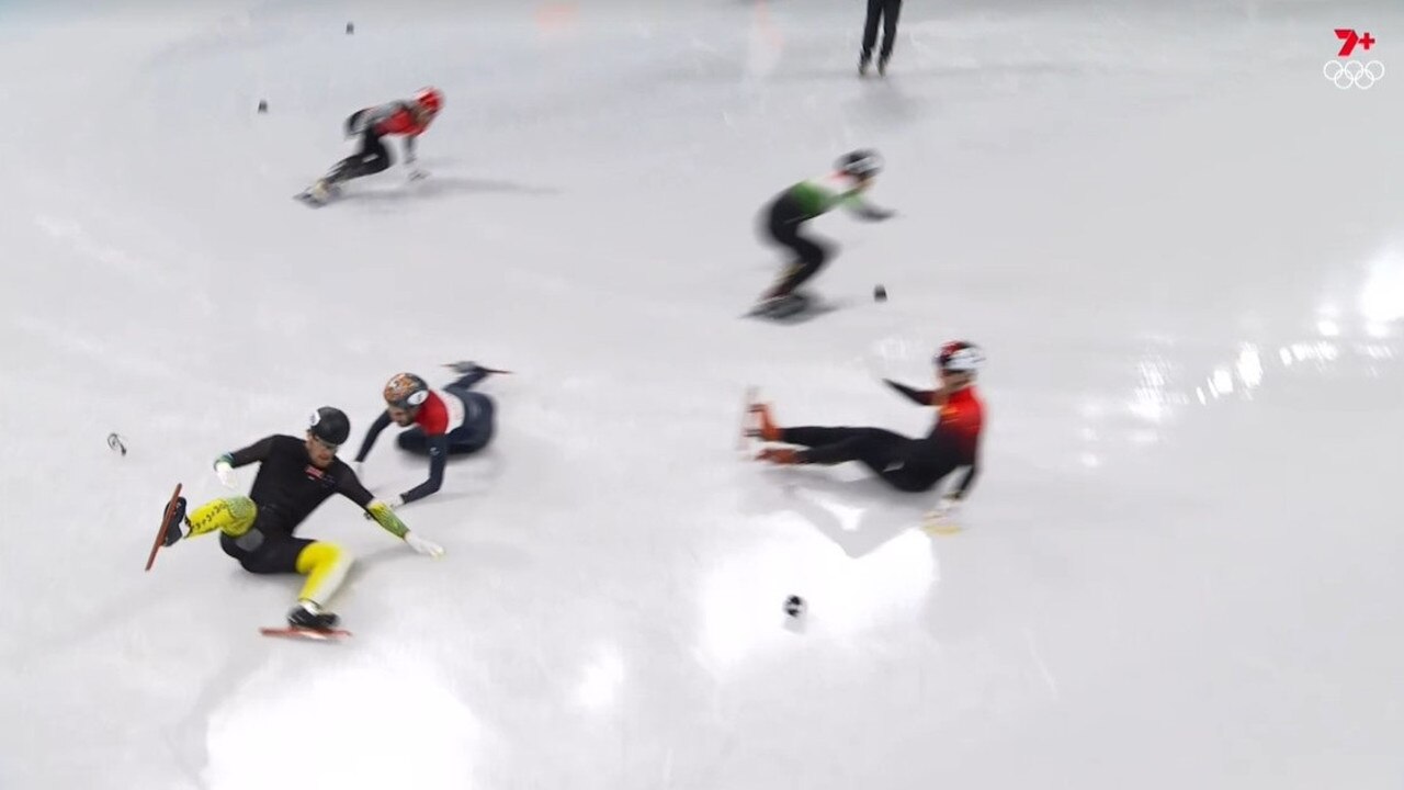 Brendan Corey crashes out of the short track speedskating, as Turkey’s Furkan Akar (top left) comes from nowhere to win his quarter-final.