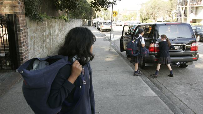 Parents are worried children are having their photo taken by strangers on their way to and from school.