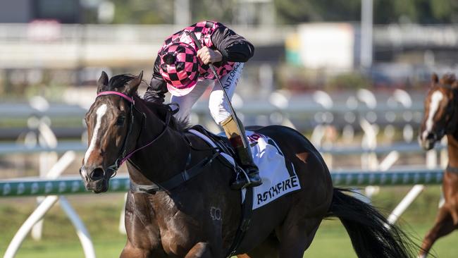 Jockey Jim Byrne rides Rothfire to victory in the J.J. Atkins. Picture: AAP/Michael McInally, Racing Queensland