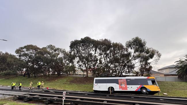 A crane is being called in to drag the bus back onto the tracks. Picture: Roy Vandervegt