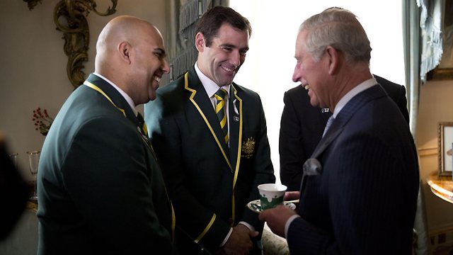 Prince Charles (R) talks with Australia national rugby league team manager Gareth Holmes (L) and team captain Cameron Smith (C) during a reception for the Rugby League World Cup at Clarence House.
