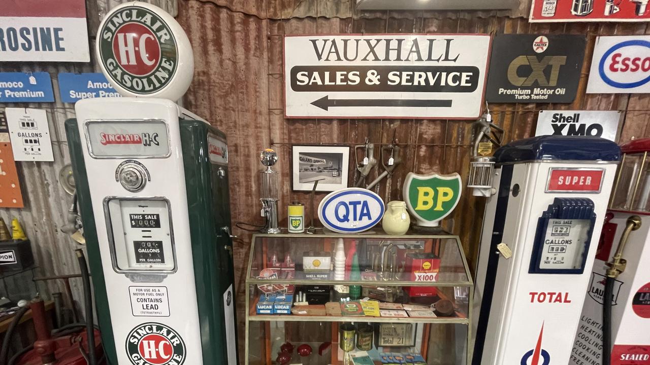 Vintage petrol bowsers, oil bottles, and vehicle manuals from Roadside Relics on Brisbane Road, Gympie.