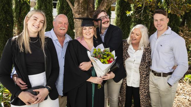 Bachelor of Education (Secondary) graduate Sarah Skinner celebrates with (from left) Katie Skinner, Jim Skinner, Luke Titmarsh, Fiona Skinner and Tom Skinner at UniSQ graduation ceremony at Empire Theatres, Tuesday, June 27, 2023. Picture: Kevin Farmer