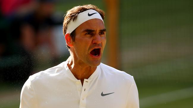 Roger Federer celebrates his victory over Milos Raonic at Wimbledon.