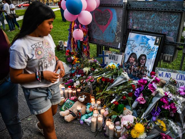 A girl visits a makeshift memorial for te shooting victims outside the Uvalde County Courthouse in Texas. Picture: AFP