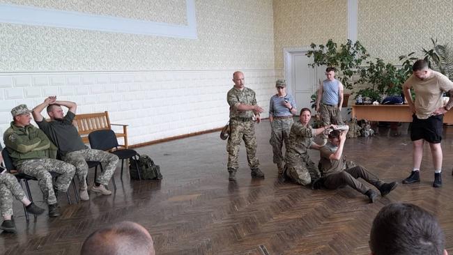 Halleshia training frontline Ukrainian fighters in combat first aid, with the help of a translator. Picture: Supplied