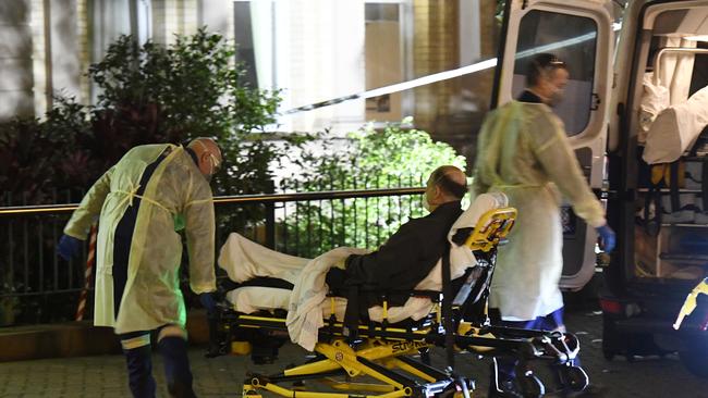 A patient with suspected coronavirus is transported to hospital. Picture: Gordon McComiskie